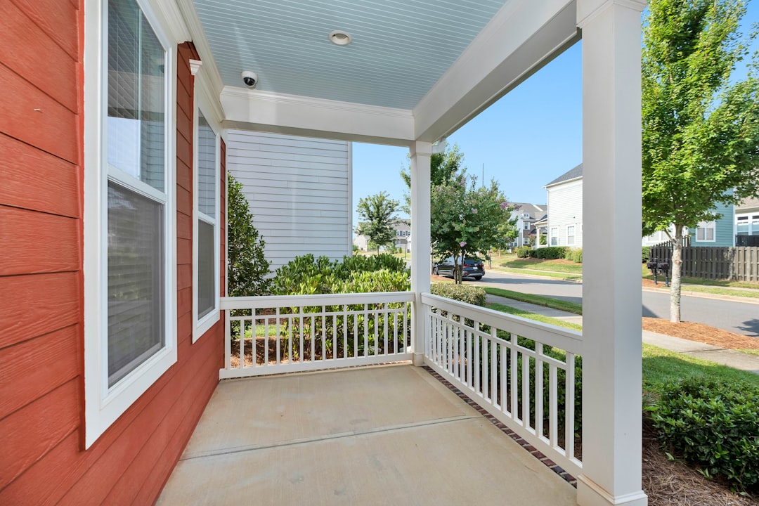 The inviting front porch of a traditional Southeast Louisiana home on a bright, sunny day, symbolizing a well-maintained and comfortable living environment.