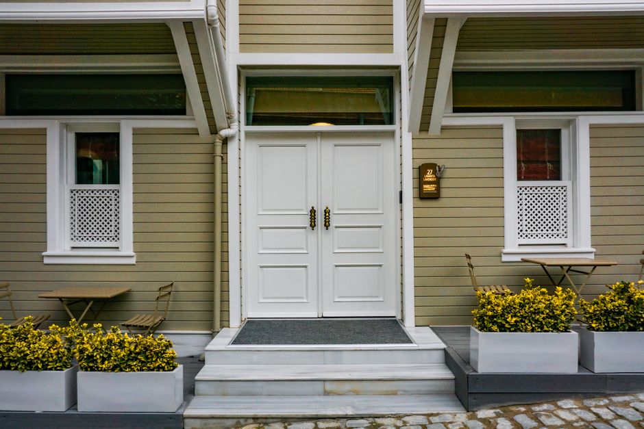 The exterior of a beautiful and well-maintained suburban home on a bright, sunny day, symbolizing security and property value.